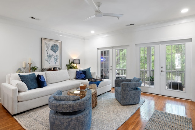 living room featuring ornamental molding, french doors, hardwood / wood-style floors, and visible vents