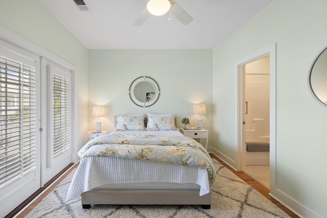 bedroom with visible vents, baseboards, wood finished floors, and access to outside