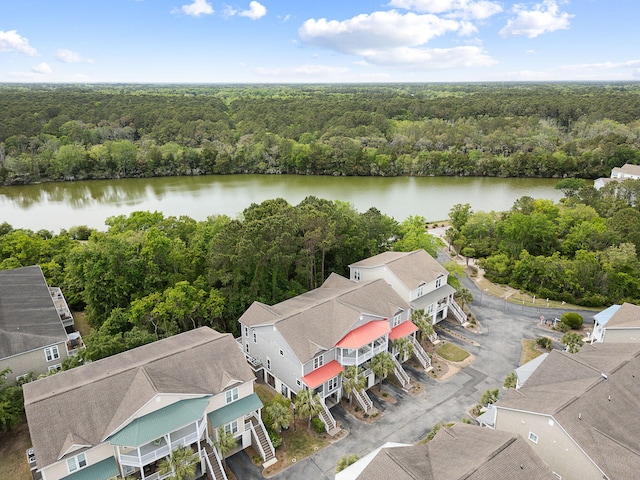 aerial view with a water view and a wooded view