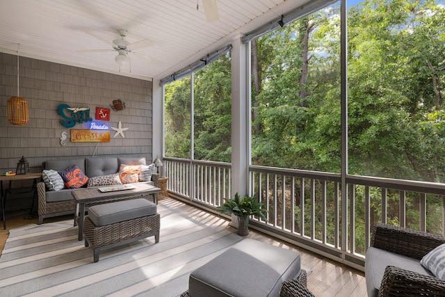 sunroom featuring a ceiling fan and outdoor lounge area
