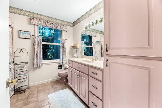 bathroom with toilet, vanity, and tile patterned flooring