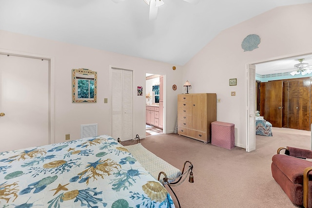 bedroom featuring vaulted ceiling, light carpet, ensuite bathroom, and ceiling fan