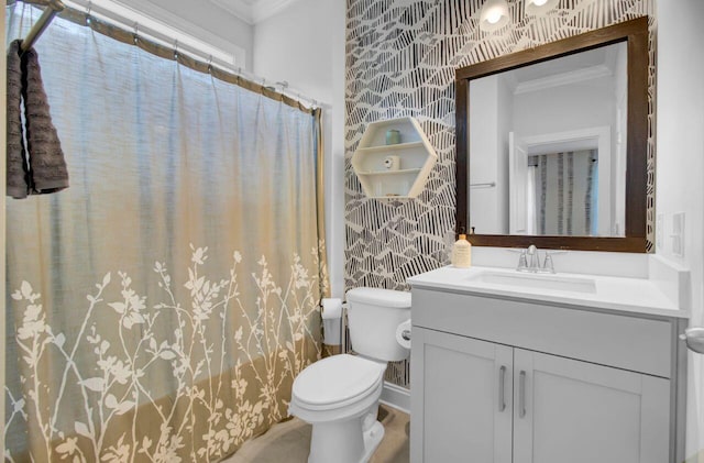 bathroom with crown molding, vanity, and toilet