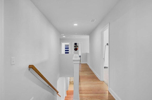 corridor with light hardwood / wood-style floors