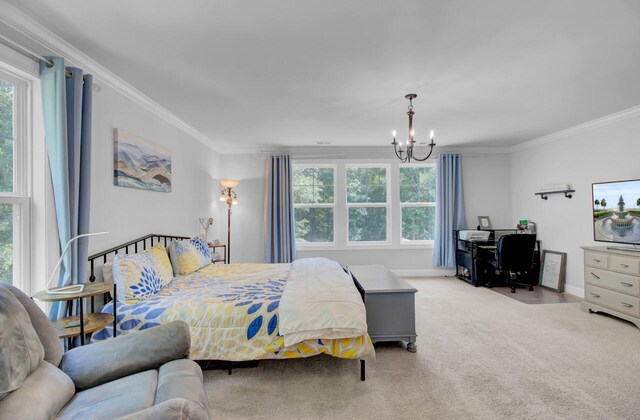 carpeted bedroom featuring ornamental molding and a chandelier