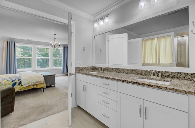 bathroom with tile patterned flooring, vanity, a chandelier, and ornamental molding