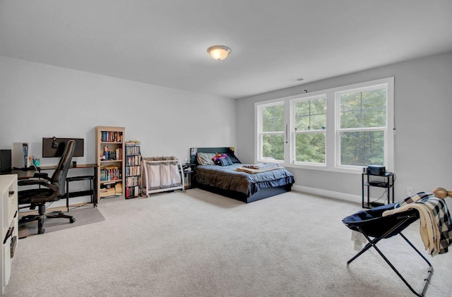 bedroom featuring light colored carpet