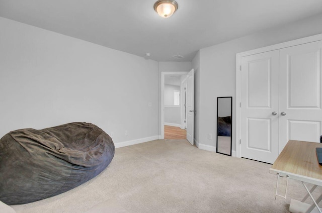 sitting room featuring light carpet