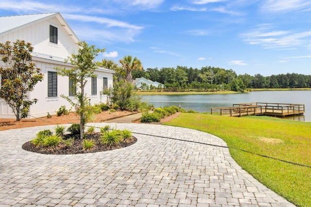 view of community featuring a lawn and a water view