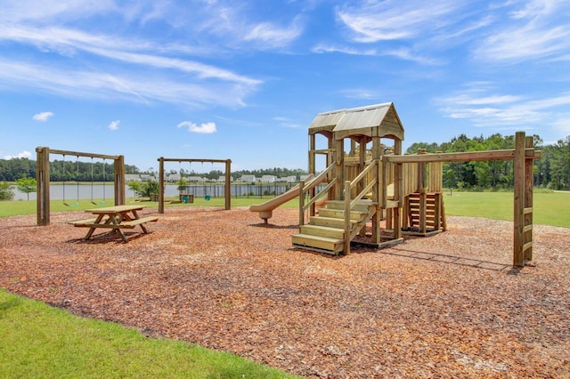 view of playground featuring a water view and a lawn