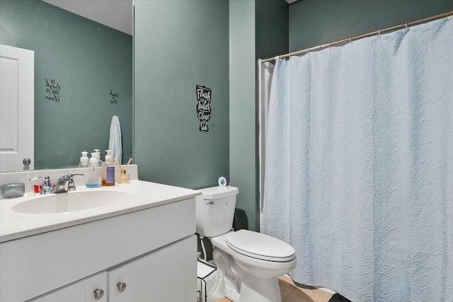 bathroom featuring toilet and vanity