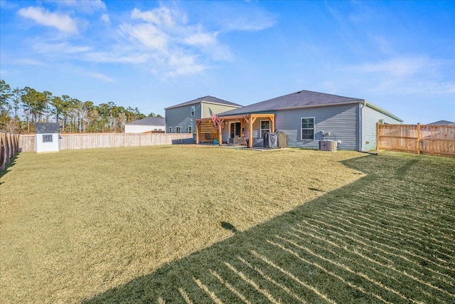 rear view of property with a lawn and a storage shed