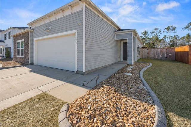 view of side of property with a lawn and a garage