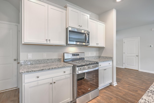 kitchen with stainless steel appliances, dark wood-type flooring, white cabinets, light stone counters, and recessed lighting
