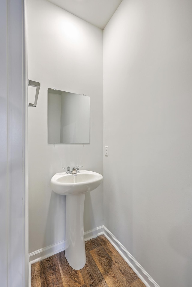 bathroom with wood finished floors and baseboards