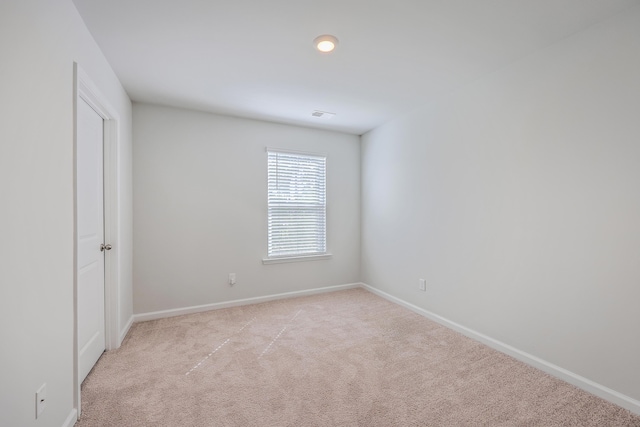 unfurnished bedroom featuring light colored carpet and baseboards