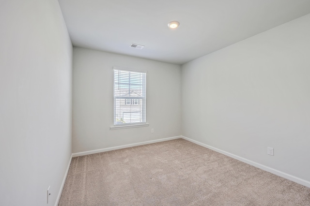 carpeted empty room with baseboards