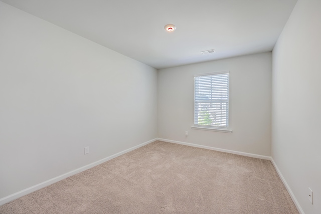empty room with light carpet and baseboards