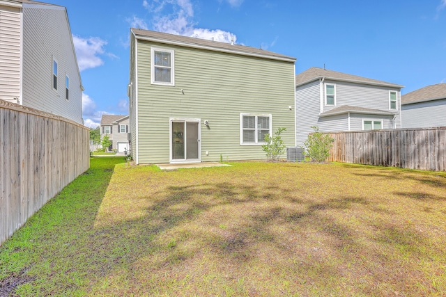 back of property featuring central AC