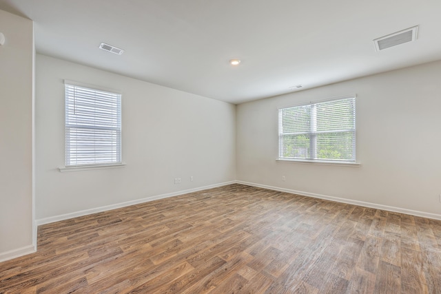 unfurnished room with wood finished floors and baseboards
