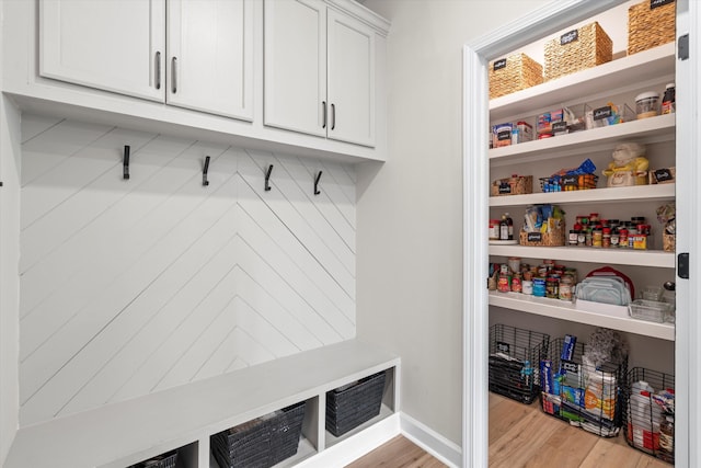 mudroom featuring baseboards and wood finished floors