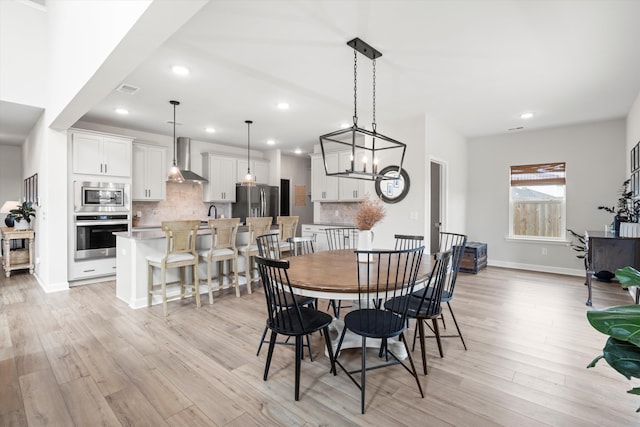 dining room with light wood-style floors, recessed lighting, baseboards, and visible vents