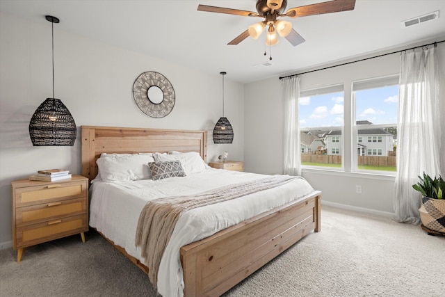 bedroom featuring baseboards, visible vents, light carpet, and ceiling fan