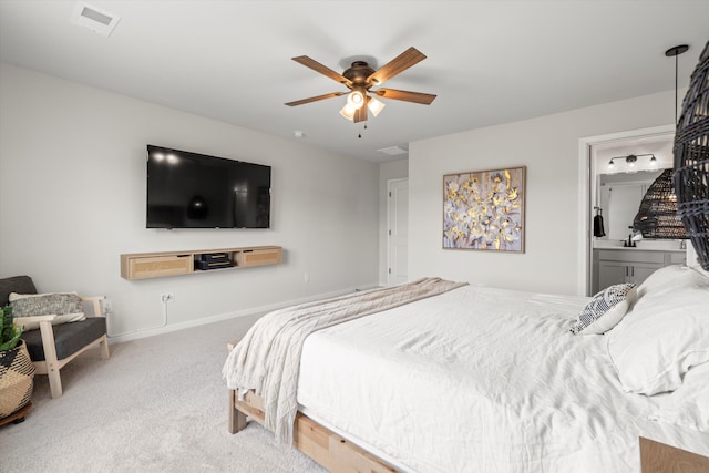 carpeted bedroom featuring baseboards, ceiling fan, connected bathroom, and visible vents