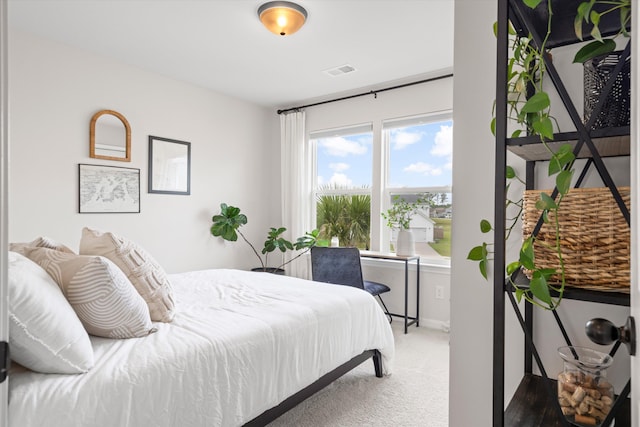 carpeted bedroom featuring baseboards and visible vents