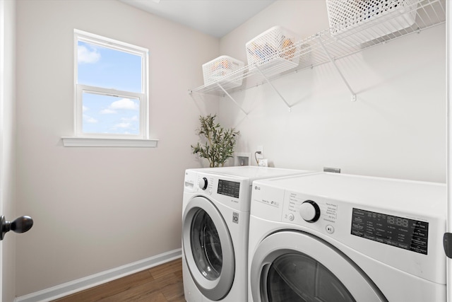 washroom featuring baseboards, laundry area, independent washer and dryer, and wood finished floors