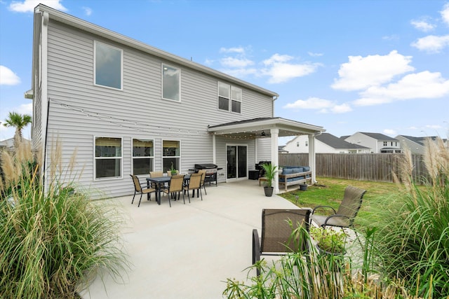back of property featuring ceiling fan, a fenced backyard, and a patio area