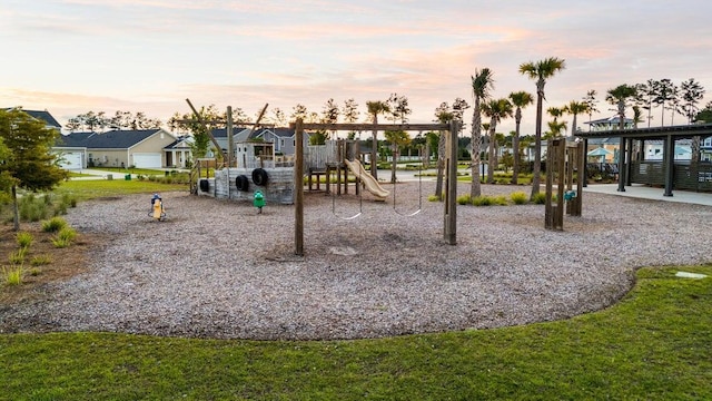 playground at dusk featuring a residential view and playground community