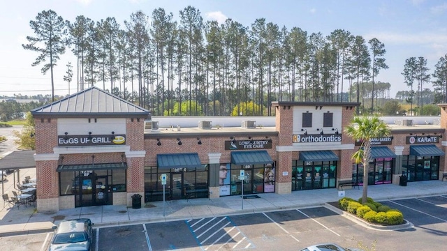 view of building exterior featuring uncovered parking