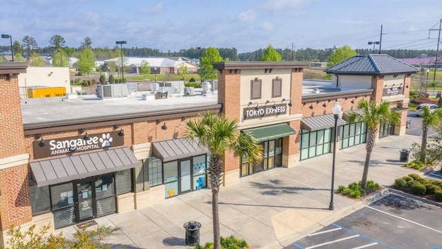 view of building exterior featuring uncovered parking