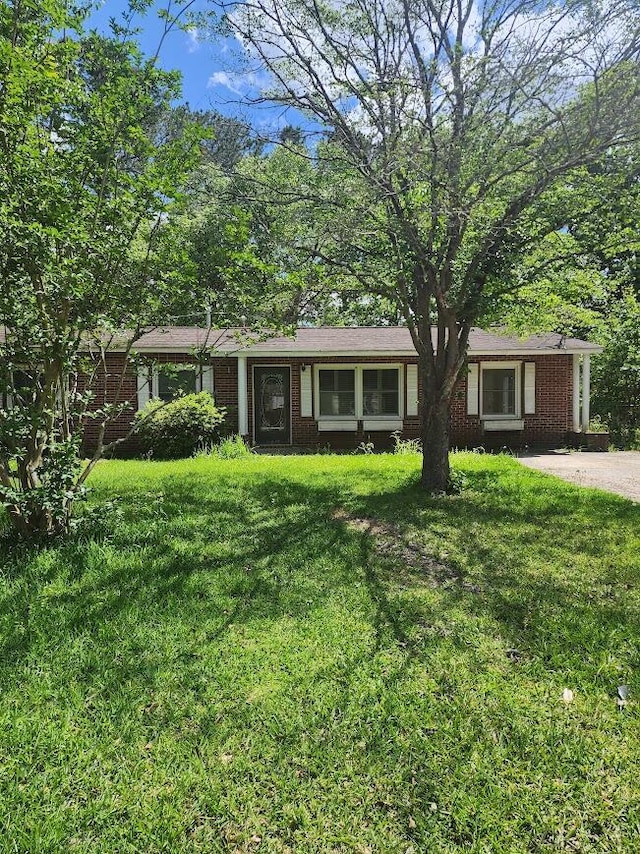 ranch-style house with brick siding and a front lawn