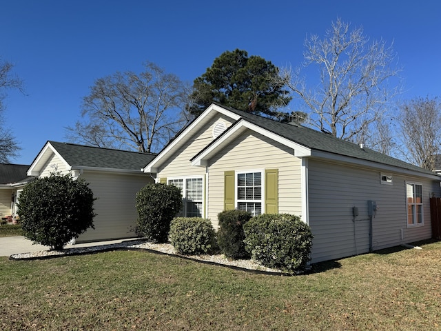 view of property exterior with a yard