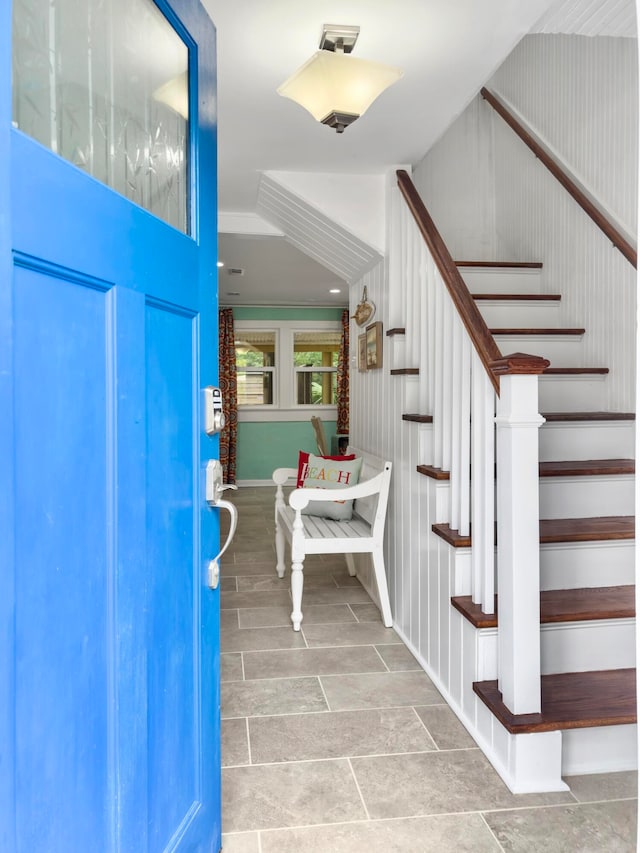 foyer with wood walls