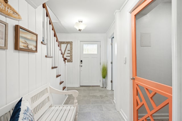 foyer featuring crown molding