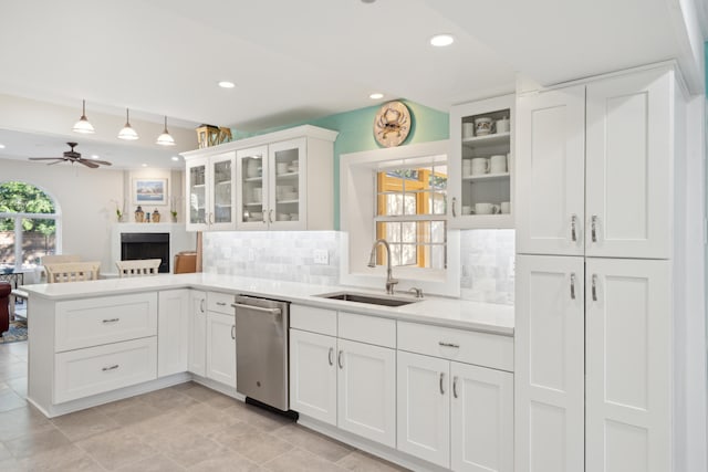 kitchen with ceiling fan, sink, decorative backsplash, kitchen peninsula, and white cabinetry