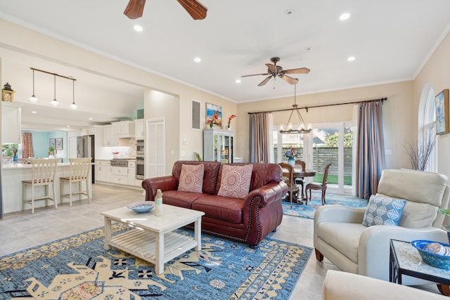 living room featuring light tile patterned floors, ceiling fan with notable chandelier, and ornamental molding