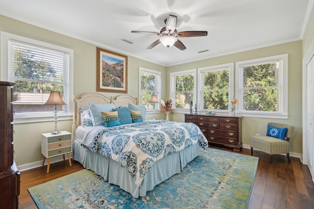 bedroom featuring multiple windows, ceiling fan, and dark hardwood / wood-style flooring