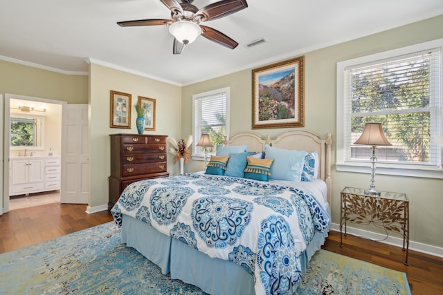 bedroom with crown molding, connected bathroom, hardwood / wood-style flooring, and ceiling fan