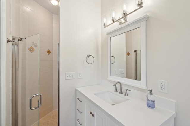 bathroom featuring vanity and a shower with shower door