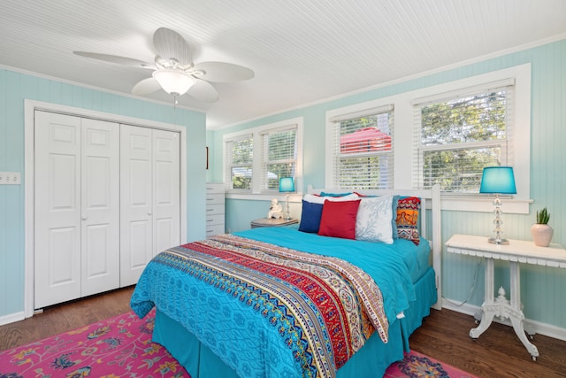 bedroom with dark wood-type flooring, a closet, multiple windows, and ceiling fan