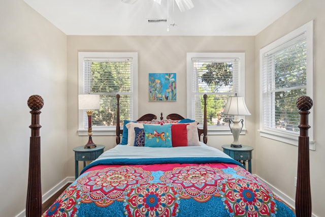 bedroom featuring multiple windows and ceiling fan