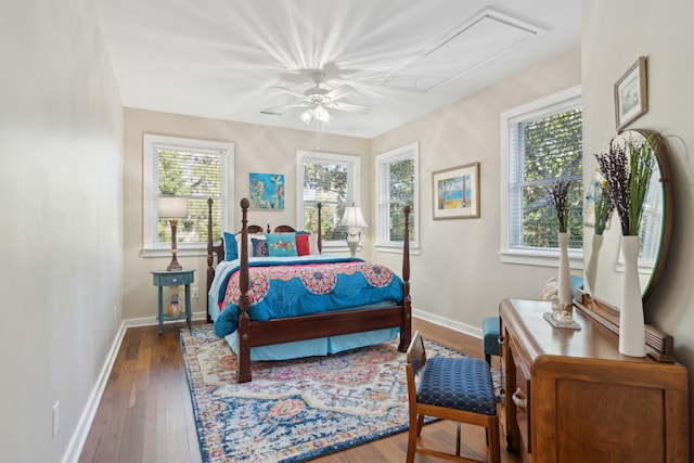 bedroom with multiple windows, ceiling fan, and dark wood-type flooring