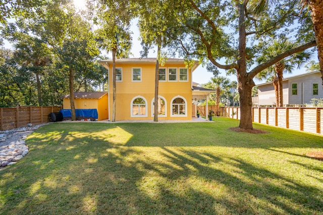 back of house featuring a lawn