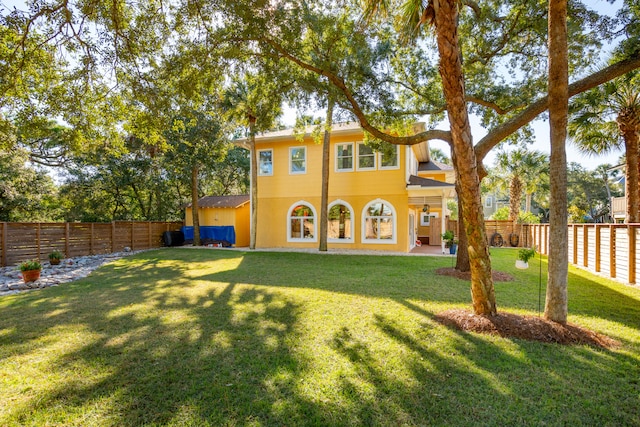 rear view of property featuring a yard