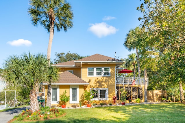 view of front of home with a front yard and a deck