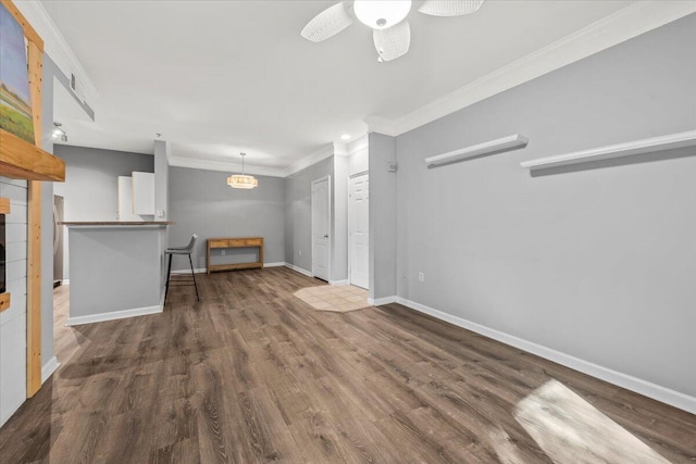 unfurnished living room with ceiling fan, dark hardwood / wood-style floors, and ornamental molding